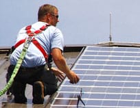 A PV panel fitter on the roof