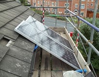 Installing solar panels on a roof requires scaffolding